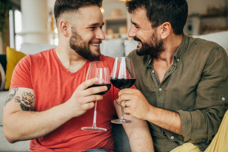 Gay couple enjoying wine