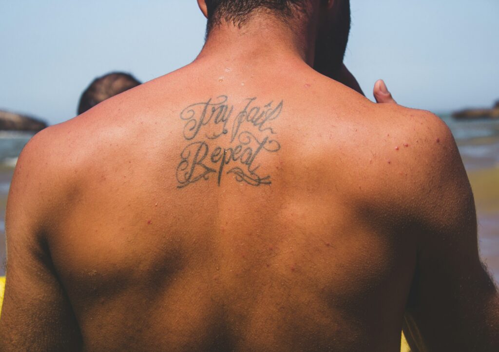 man at beach tattoo