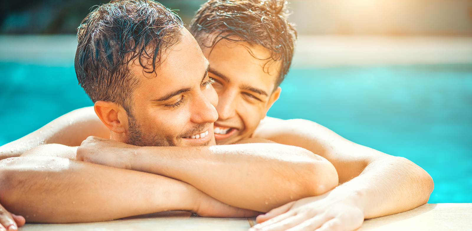 Gay couple relaxing in swimming pool