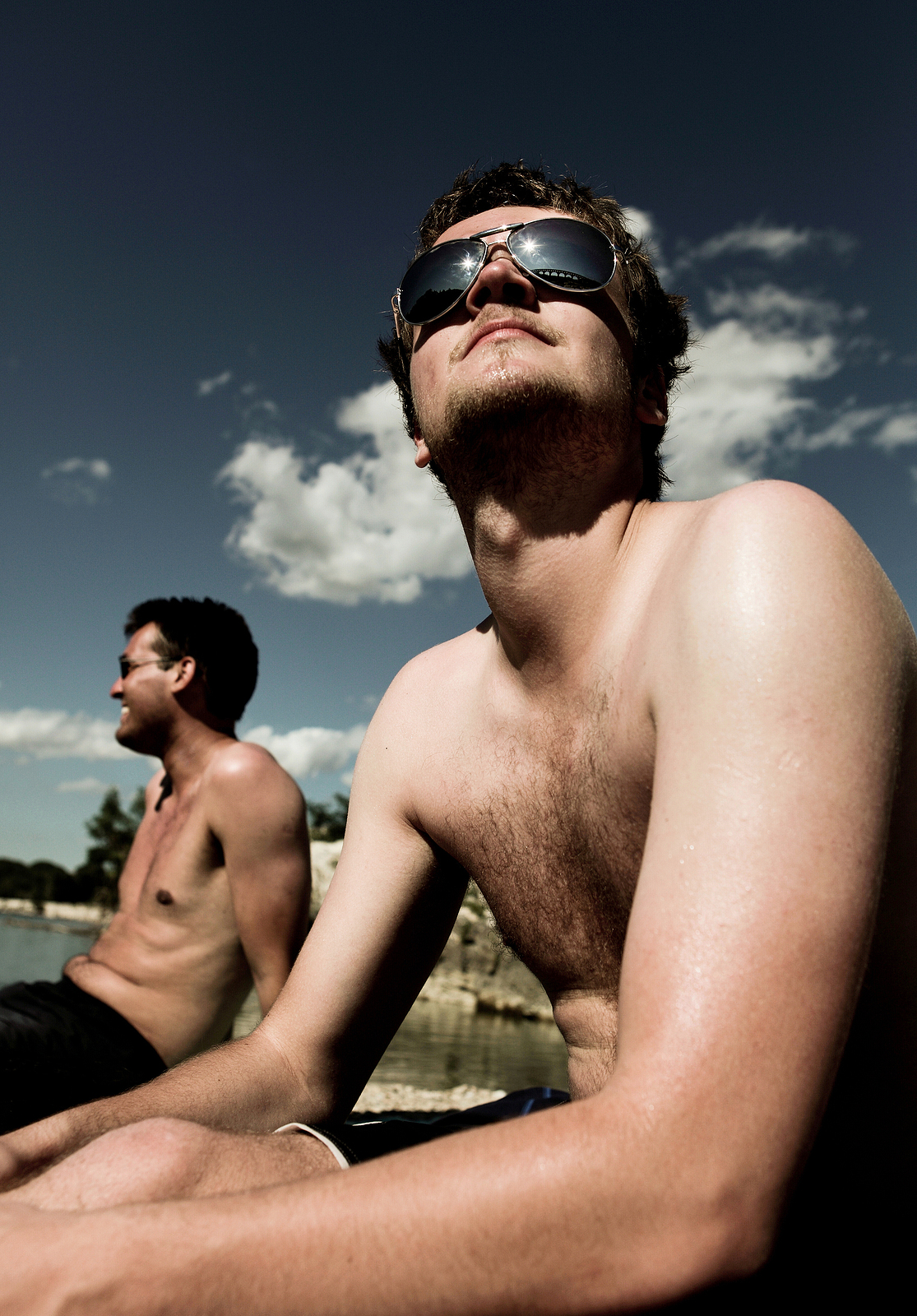 Two gay men sitting on a beach