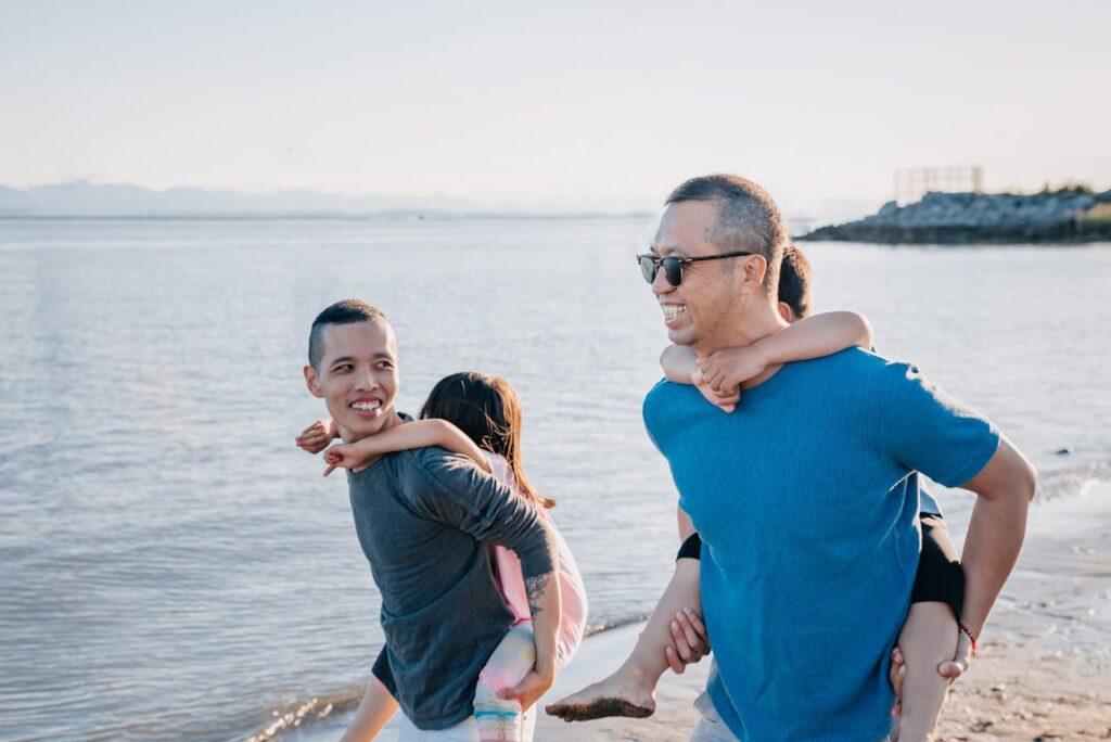 Gay dads on the beach with children