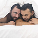 Gay couple under duvet